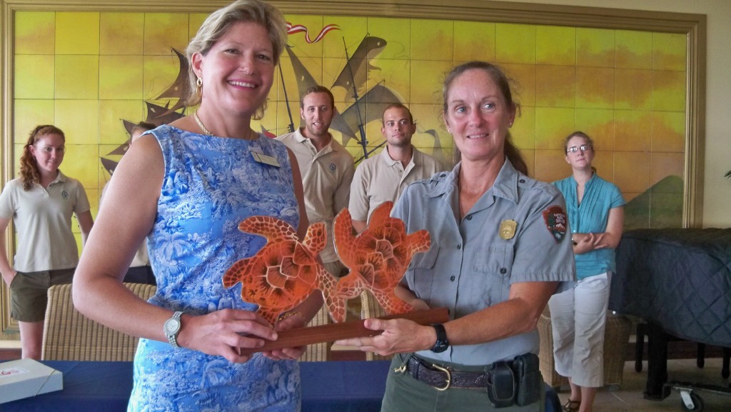 Buccaneer owner Elizabeth Armstrong (left) receives a plaque from the National Park Service's Zandy Hillis-Starr.