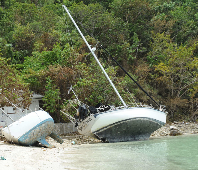 Two sailboats washed up on the beach of Water Island. (Photo courtesy of Government House)