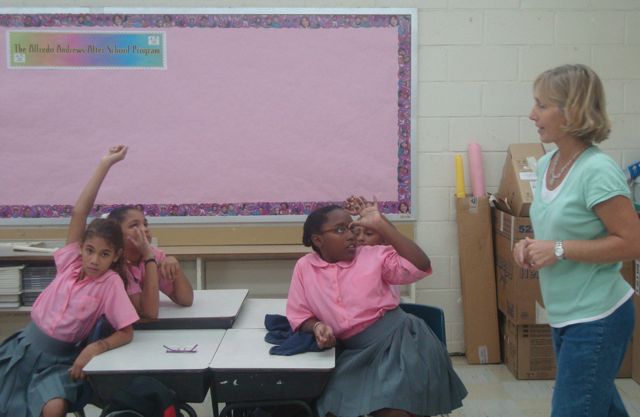 Therese Donarsk, right, helps student plan how to take care of a pet during a hurricane at the Alfredo Andrews Elementary School after-school program.