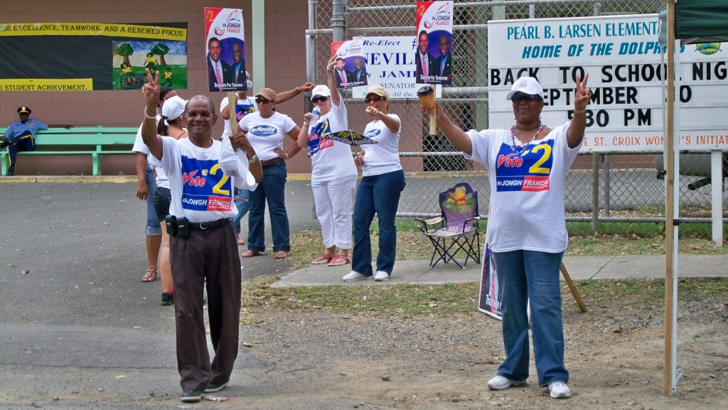 Backers of Gov. John deJongh Jr. and Lt. Gov. Gregory Francis  show two fingers in support.