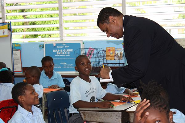 Gov. John deJongh Jr. signs an autograph for 9-year-old K'jhani Biscombe (left).