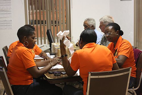 Board of Elections officials tally the results from Saturday's primary.