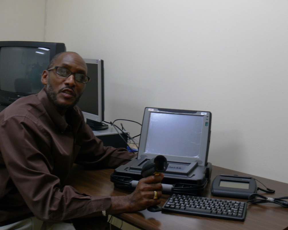 Supervisor of Elections John Abramson Jr. demonstrates one of the new "e-polling" books.