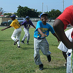 Janshimo Hanley (center) runs drills Wednesday with Angels scouts.