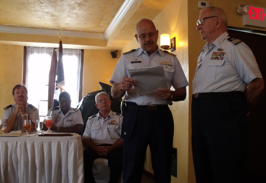 U.S. Coast Guard Capt. Eduardo Pino reads a letter from President Barack Obama to Klaus Willems thanking him for his 30 years of service in the auxiliary.