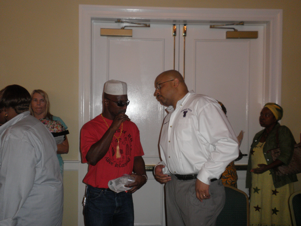Raymond Smith (left) talks with Principal Baruti Kafele.