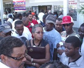 Delegate Donna Christiansen (center) helps Hans Oriol (bottom left) answer questions for Haitians.
