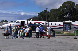 Doctors, nurses and support staff prepare to board the flight to Port-au-Prince.