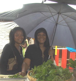 Jackie Davis and Jackie Davis &ndash; no relation &ndash; huddle under an umbrella at the fair.