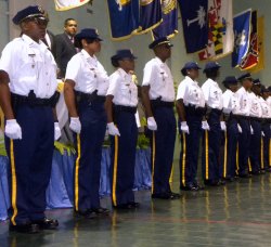 Gov. John deJongh Jr. (rear) looks over the latest graduates of the V.I. police academy.