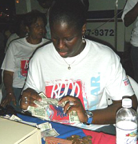 Tiffany Gumbs of Banco Popular counts donations at Saturday's concert.