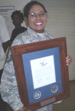 Master Sgt. Pamela S. Depusoir beams with pride after getting her letter.