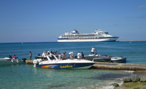 With Sunday's visiting cruise ship in the background, racers get their boats ready to go at the Fisher Street boat ramp.