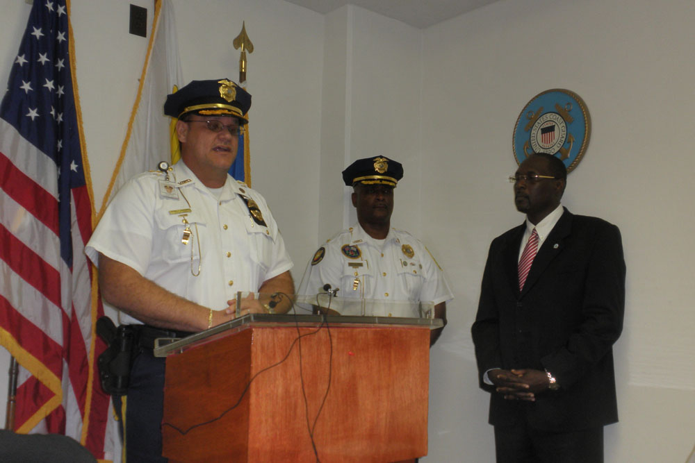 Chief Rodney Querrard addresses the press while Deputy Chief Dwayne DeGraff and Commissioner Novelle Francis listen.