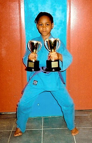 Brittany proudly displays two first place trophies from a 2009 competiton at Antilles School. (Photo courtesy Joseph Leonard)