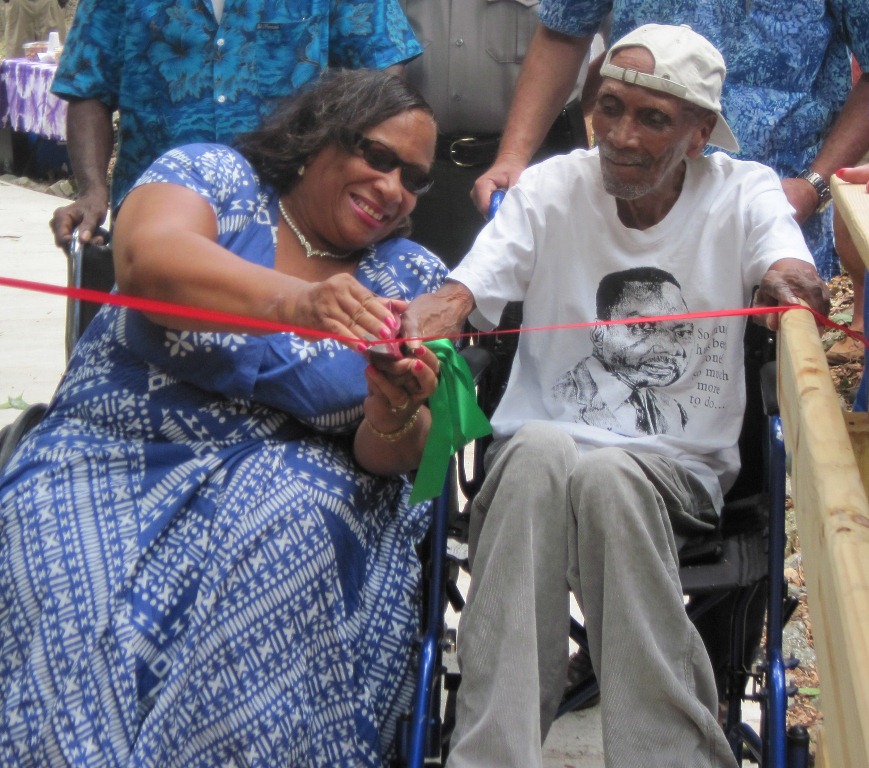 Janet George-Carty and Guy Benjamin cutting the ribbon at the Cinnamon Bay trail.