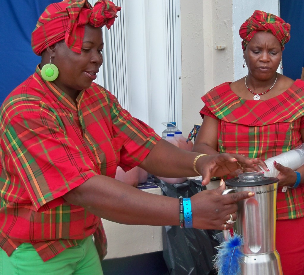 Ann George (left) and Hazel St. Ange, from Country Snack Stand, mixing up smoothies made from local fruit.