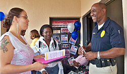 Rhalina LaPlace (left) and Sheena Tonge talk to Rolston Friday Jr. of the Department of Licensing and Consumer Affairs.