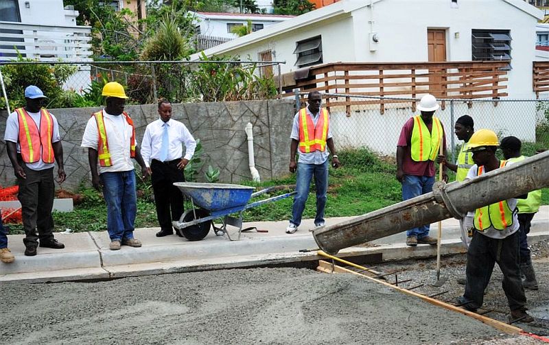 Crews pour concrete on the Polyberg road in preparation to restoring two-lane traffic on the roadway this week.