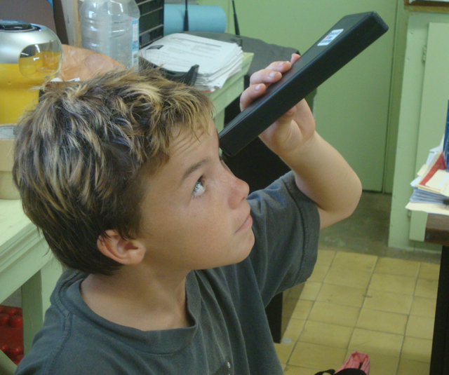 Good Hope student Mason Trask enjoys the view through a spectroscope.