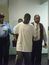 This flle photo from July 2010 shows Tyson being led by police up to Bureau of Corrections to await his advice of rights hearing.
