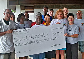 St Patrick's Day Parade committee members, Special Olympics board members and athletes gathered Saturday for the check presentation.