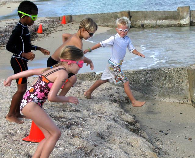 Young racers hit the water at the start of the Splash N’Dash race Sunday morning at Chenay Bay. 