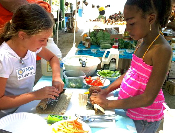 Ella Barr, left, instructs a sushi student.