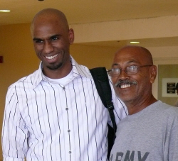Orlando Santos (left) greets his proud father, Enrique Santos, at Rohlsen airport.