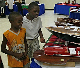 Ashawn Allen (left), and Jah'Noah Benjamn admire handmade wooden boats.