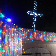 Christmas lights in Estate Mafolie are crested by a white lighted cross.