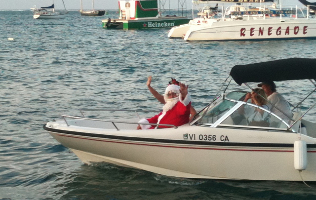 Santa Claus arrives by boat. (John Baur photo)