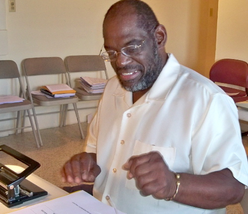 Carnell Troutman does paperwork at the Men's Coalition.