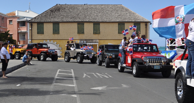 A line of flag-bedecked Jeeps takes part in the parade.