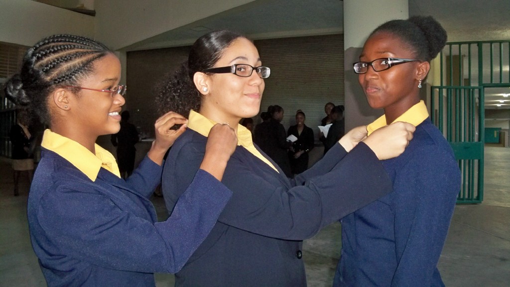 Good Hope’s Cherelle Lee, Gindra Medrano and Nathalie Taylor (pictured from left) straighten their collars before the induction ceremony.