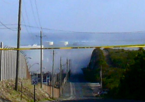 Smoke from a fire at Hovensa obscures the road leading to the refinery.