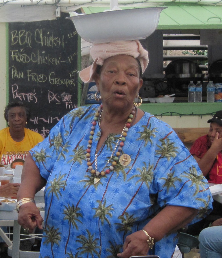 Delila O’Connor showed the students how to use a towel folded on top of her head to carry wood. Removing the wood, she then balanced a bowl.