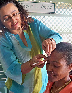 Serena Sundaram (left) performs acupuncture on Beverly Hermon.