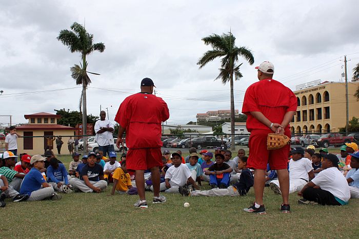 Angels' scouts Ham and Marigny teach local kids the fundamentals of baseball.