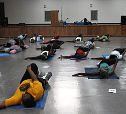 Tanja McPherson (on stage) leads a yoga class.