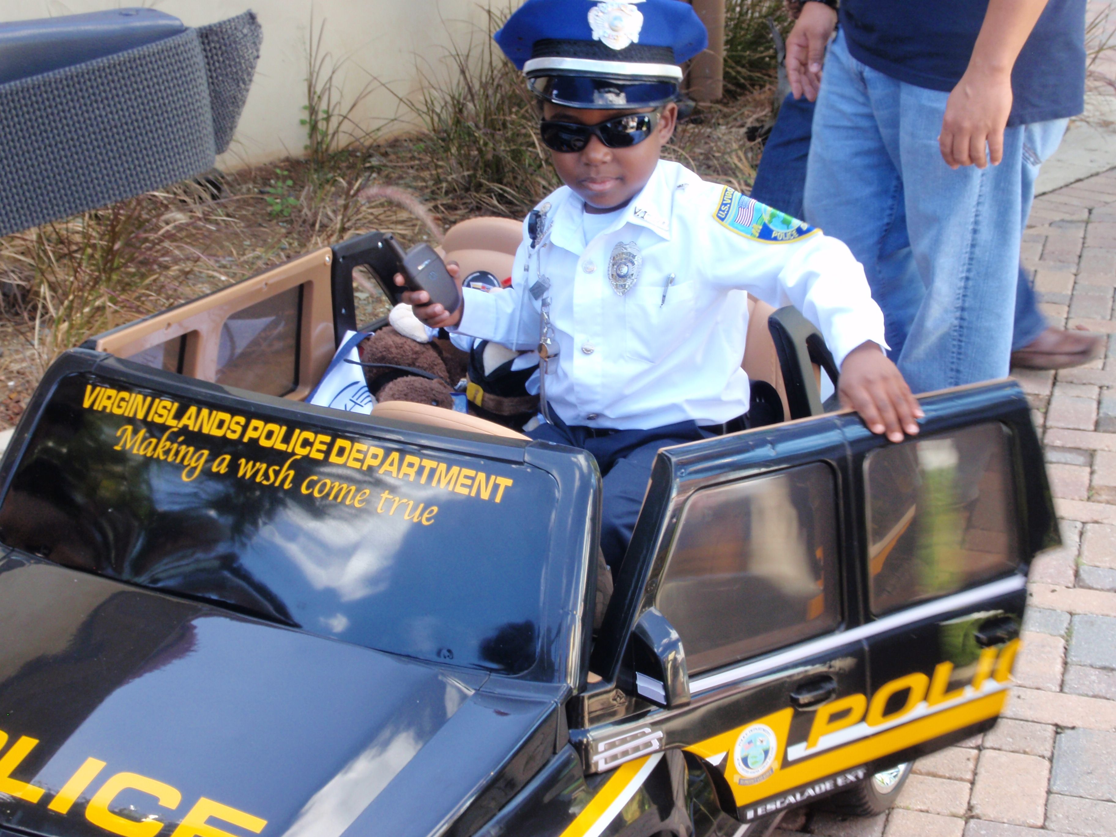 Pint-sized policeman J'Len Ford in his Make-A-Wish mini-cruiser.