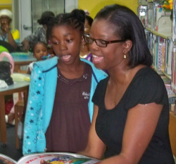 Aziza Williams, 6, reads with DPNR's Alicia Barnes.