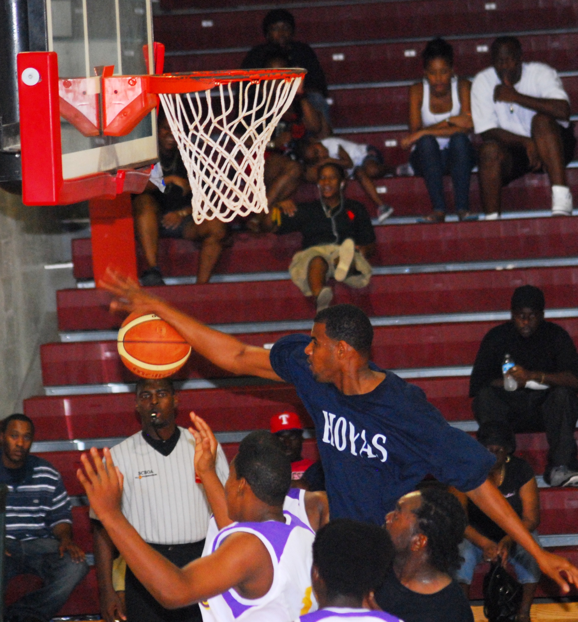 The Hoyas' Anthony Theodore goes high for the block.