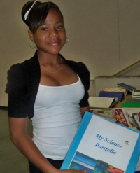 Nhaquifa Russell, an 8th grader at Elena Christian Junior High School, shows her science portfolio. 