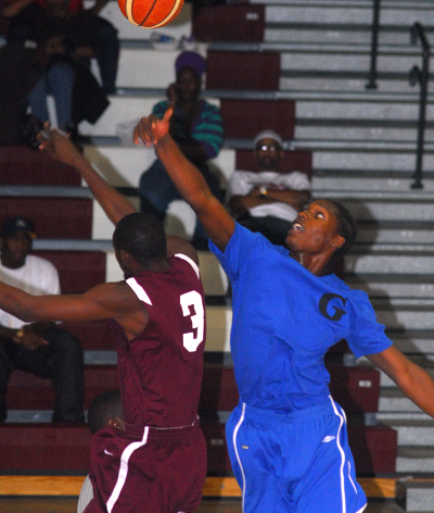 Guidance’s Raydell Dennis (right) wins the opening tip.