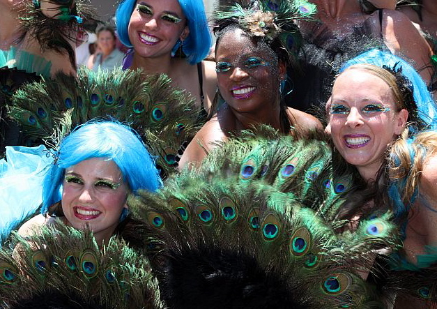 The Luna'tics celebrate beauty with their peacock-inspired costumes.