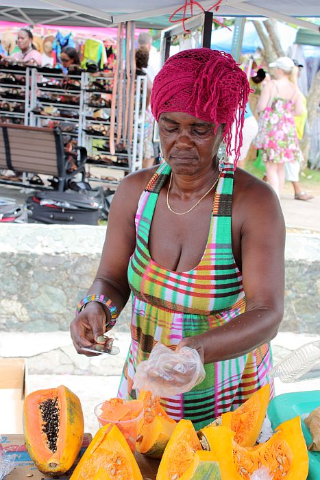 Martha Pacquett cuts up fresh pumpkin and papaya for customers.