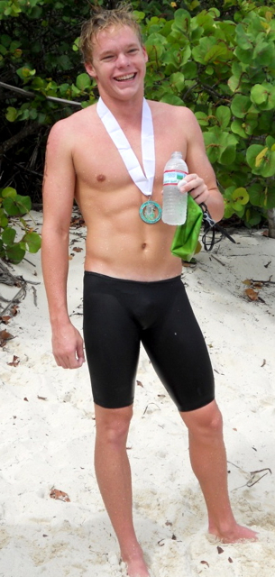 Bryson Mays proudly wears his medal for winning the eighth annual Beach to Beach Power Swim.