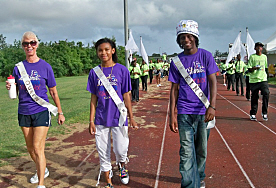 Cancer survivors and Relay for Life Royalty Val Stiles (from left), Markicia James and Jovan J. Augustin lead the march.