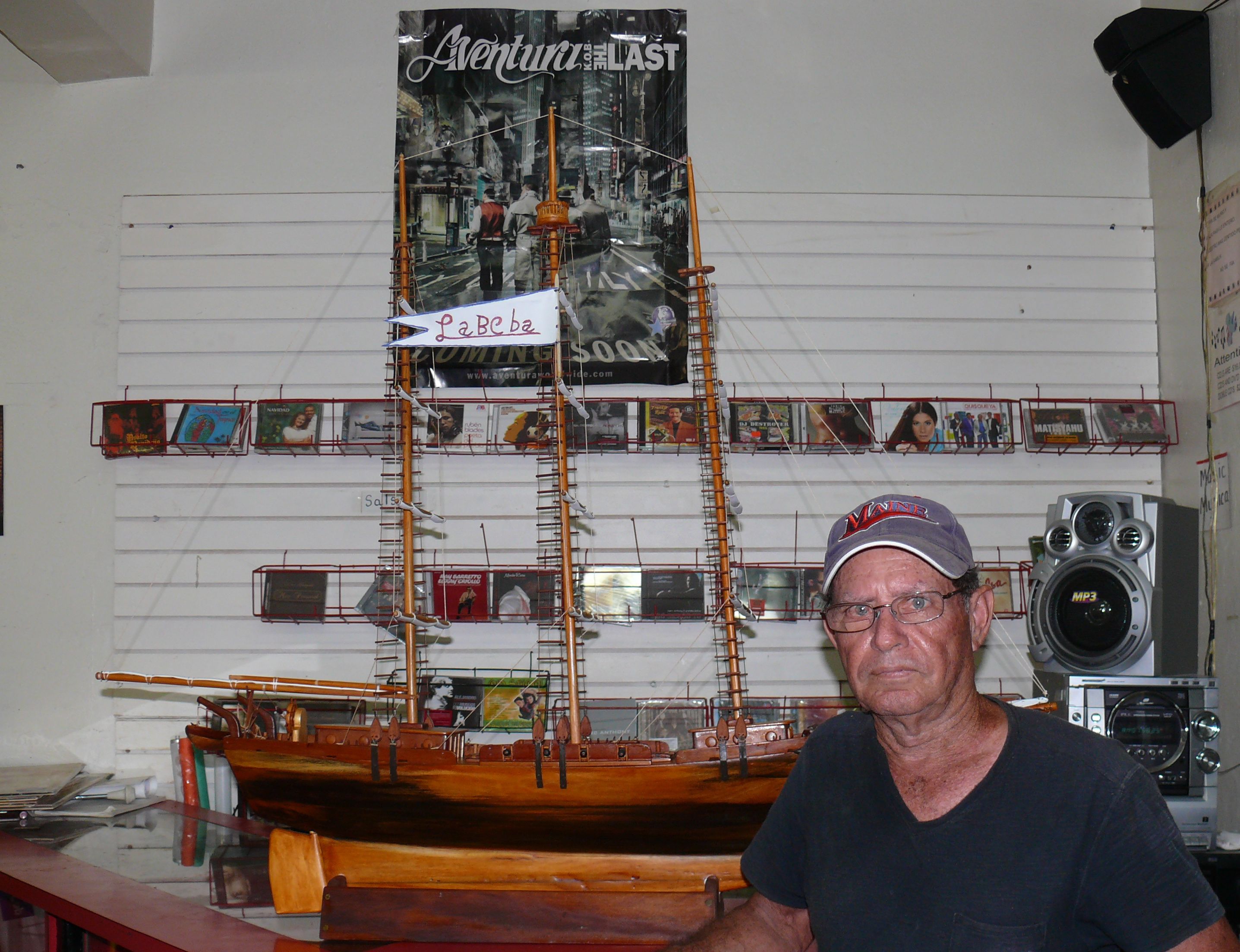 Jim Cruz Rios with his model boat, on display at J and W Grocery in Christiansted.